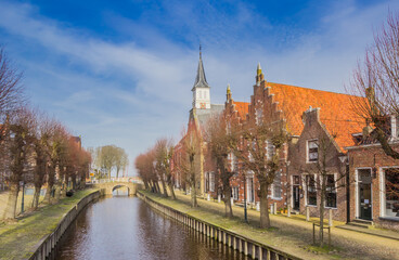 Central canal with the protestant church and old houses in Sloten, Netherlands