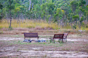 Rusty park benches around a firepit on the Atherton Tableland in Tropical North Queensland, Australia