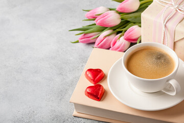 Spring holiday concept. Coffee, book, tulips and gift box.