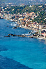 The coast of Eastern Sicily with the city of Giardini Naxos, an ancient Greek colony