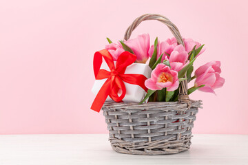 Fototapeta na wymiar Pink tulip flowers bouquet and gifts