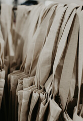 Eco-bags in a natural shade, hanging in the store. Natural products, no waste