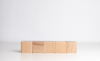 line of wooden cubes on the white background