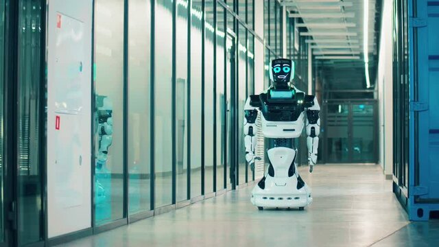 Robot walks along the hallway. Futuristic technology concept. Future, innovation, science, robot concept.