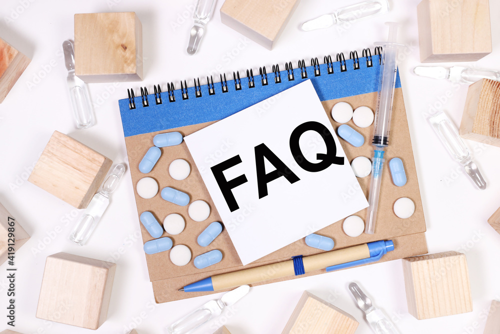 Poster faq frequently asked questions. text on paper. text on notepad on white background. near the wooden 
