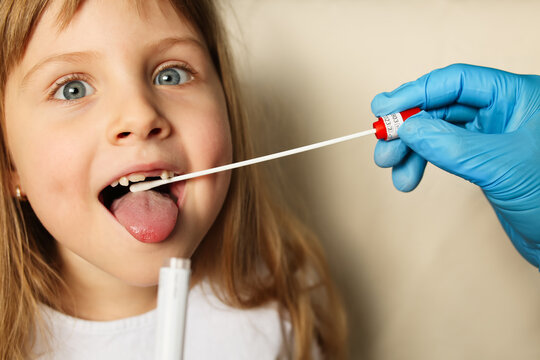 Doctor Hands In Protection Gloves Putting Coronavirus Test Swab Into Kid Mouth