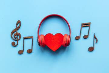 Red headphones with musical notes and heart shape. Listen to the music concept