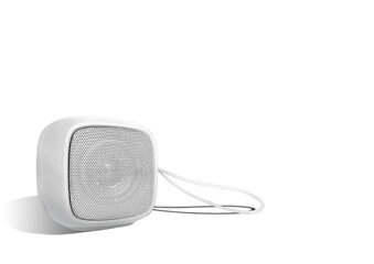 Mini wireless speaker with lanyard isolated on white color background. Rounded square shape.