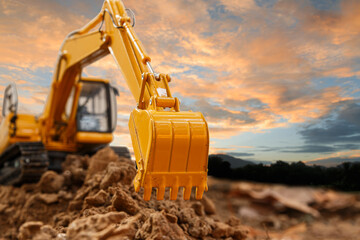 Excavator with Bucket lift up are digging the soil in the construction site on the sky  background