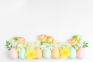 Fototapeta na wymiar Creative layout composition of flowers and easter eggs on pastel background.