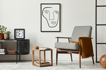 Stylish scandinavian composition of living room with design armchair, black mock up poster frame,...