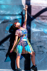 Fototapeta na wymiar Young woman wearing holographic clothes