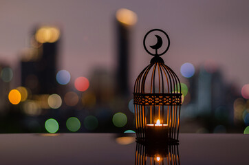 Lantern with dusk sky and city bokeh light background for the Muslim feast of the holy month of...