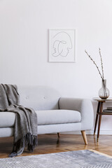 Stylish scandi interior of home space with design grey sofa, retro wooden table, mock up poster...