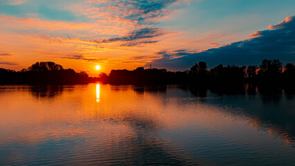 Naklejka premium Beautiful sunset with reflections near Plattling, Isar, Bavaria, Germany