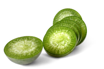 Green radish is cut into juicy pieces for cooking and laid out on a white background. Healthy eating. Diet. Ecological products. Vegetarianism.