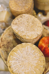 Heads of organic homemade cheese at the food fair