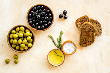 Italian food background with olives oil and sliced bread. Top view