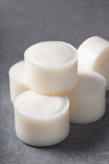 Handmade natural herbal coconut  kitchen soap bar white color on grey concrete background.