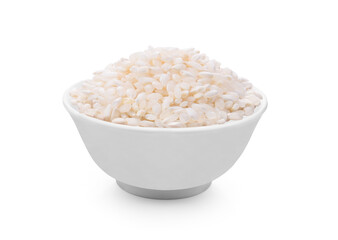 White bowl of raw organic arborio risotto rice on white background.