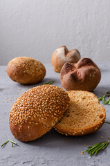 Vertical image.Buns with sesame on the grey table.Vertical image