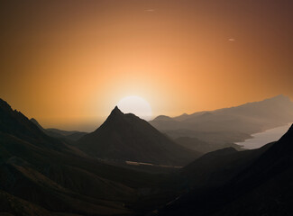 Mountain landscape with orange sky. during sunset