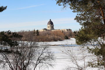 Pre-spring south view Saskatchewan Legislature historic building from frozen Wascana Lake