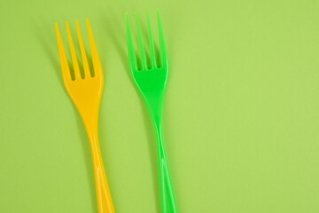 plastic forks on a green background
