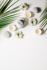 Naklejka na ściany i meble Composition with symbolic objects for spa salon. Stone therapy attributes for cosmetic procedures. Conceptual image, rocks and flowers representing balance. Close up, copy space, top view, background.