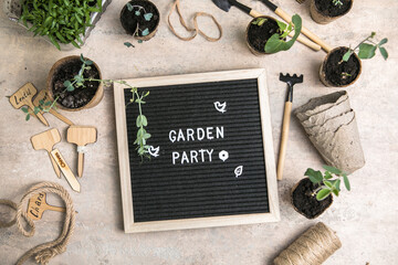 Letter board with text Garden party. Planting seeds in Biodegradable paper eco-friendly seed pots....