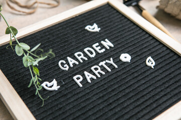 Letter board with text Garden party. Planting seeds in Biodegradable paper eco-friendly seed pots....
