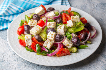 Greek salad with fresh vegetables, feta cheese and kalamata olives. Healthy food.