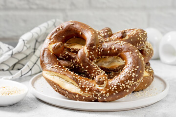 German pretzel. Pretzels with sesame seeds on the light gray kitchen table