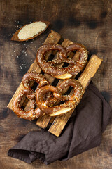 German pretzel. Sesame pretzels on the brown wooden kitchen table. Top view