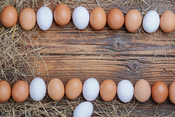 Fresh eggs arranged on a wooden table in an organic farm with Copy space - top view.