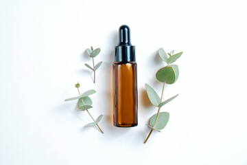 Brown transparent bottle with 100% pure hyaluronic acid serum for skin vaccination and dropping on wood textured table background. Close up, copy space, top view.