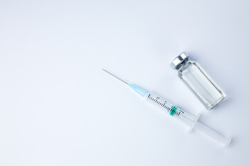 Vaccine vial and syringe injection on a white background. Vaccination, immunization, treatment to...
