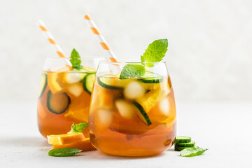 Summer green tea cucumber orange mocktail in glasses. Space for text.