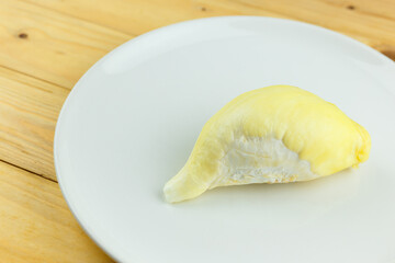 Single Durian on white plate, King of fruit of Thailand.