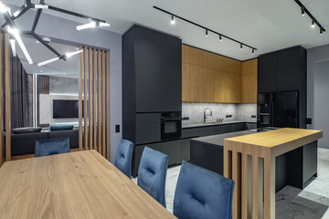 Modern grey and wooden interior of kitchen in luxury private house.
