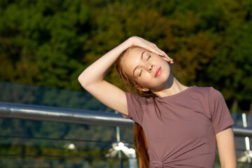 Lovely ginger fitness woman warms up
