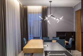 Fototapeta premium Modern grey and wooden interior of kitchen in luxury private house.