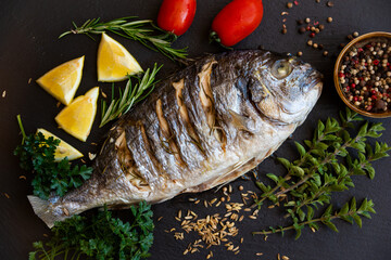 Roasted dorado fish with herbs and vegetables , healthy food