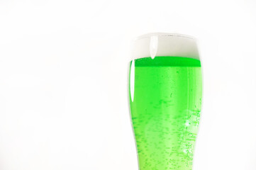 A pint of green beer for st patrick's day on a white background. Traditional Irish drink for a holiday