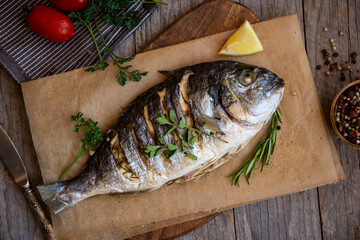 Roasted dorado fish with herbs and vegetables , healthy food