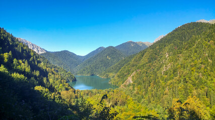 Fototapeta na wymiar Wonderful view of Lake Ritsa surrounded by a mountain range. Taken in Abkhazia