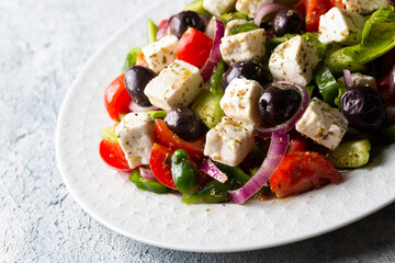Greek salad with fresh vegetables, feta cheese and kalamata olives. Healthy food.