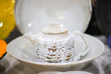 White ceramic teapot in a plate