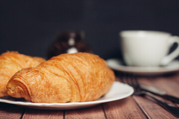 croissants white plates on the table kitchenware a cup of coffee meal dessert