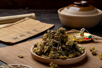 Ancient Chinese medicine books and herbs on the table.English translation：Emperor's Internal...